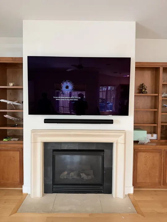 TV and soundbar above a classic fireplace mantel, Houston TX