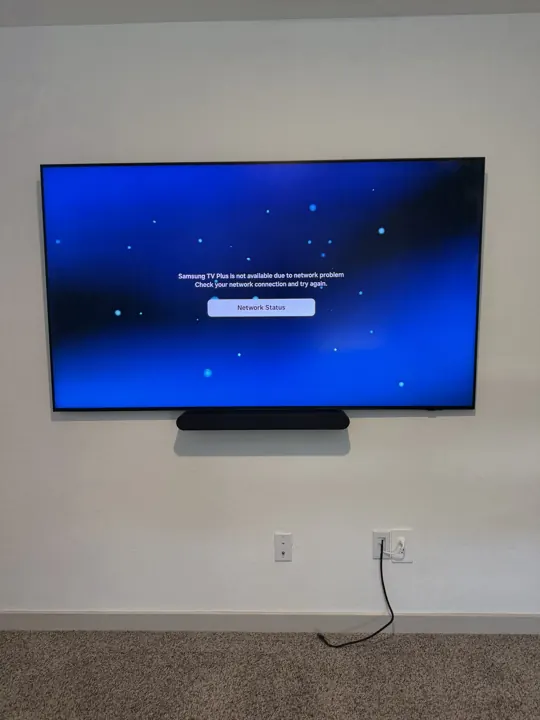 Large TV with soundbar mounted on drywall, Houston TX
