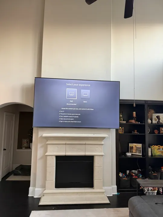 TV mounted above a white fireplace in a living room, Houston TX