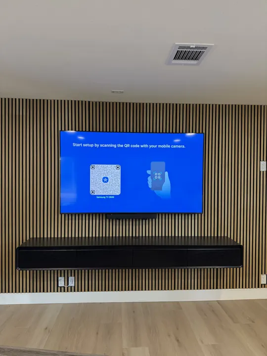 TV on a wood slat accent wall with floating media console, Houston TX